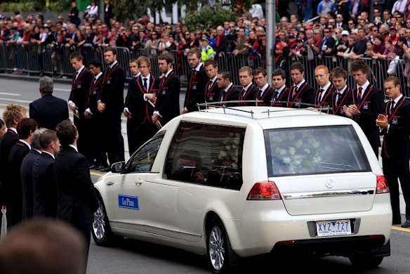 Melbourne footballers form a guard of honour to farewell club great Jim Stynes. 