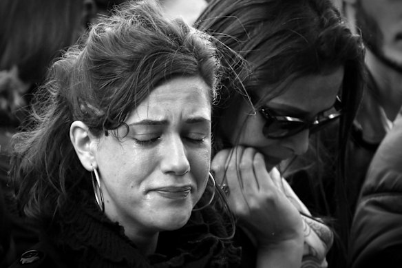 Faces of Paris. Parisians silently paid respect to the 129 people killed in the terror attack in Paris across many memorial sites including Le Carillon bar.