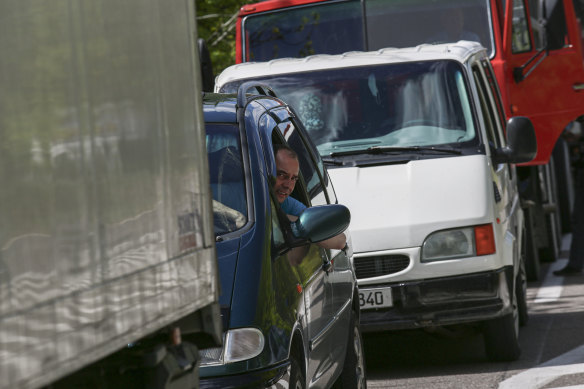 People wait in vehicles to cross the border seen from the Moldovan side of the Varnita-Bender crossing between Moldova and the Moldovan separatist region of Transdniester.