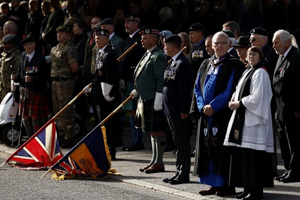 BALLATER, ABERDEENSHIRE - SEPTEMBER 11: People and members of the military gather in tribute as the cortege carrying the coffin of the late Queen Elizabeth II passes by on September 11, 2022 in Ballater, United Kingdom. Elizabeth Alexandra Mary Windsor was born in Bruton Street, Mayfair, London on 21 April 1926. She married Prince Philip in 1947 and ascended the throne of the United Kingdom and Commonwealth on 6 February 1952 after the death of her Father, King George VI. Queen Elizabeth II died at Balmoral Castle in Scotland on September 8, 2022, and is succeeded by her eldest son, King Charles III. (Photo by Jeff J Mitchell/Getty Images)