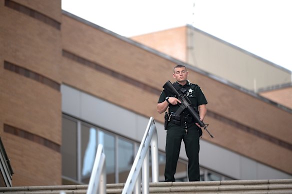A police officer stands guard outside the Orlando Regional Medical Center hospital.