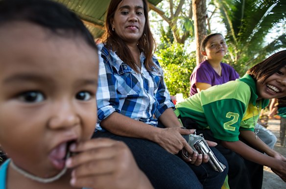 Sukanya, 42, puu yai baan, or village chief, who has a .38 calibre pistol and is part of the village defence group. Around 15 men from the vilage have been killed in the decade long conflict that has rocked the region. 