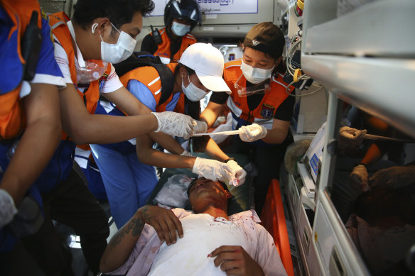 Paramedics tend to a protester injured during a demonstration.