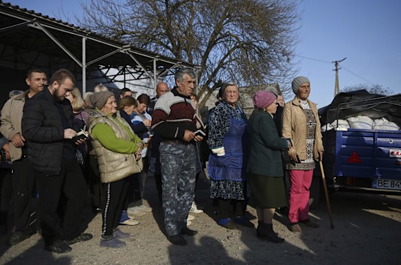 Locals at Lymany village queue for food packages at a World Kitchen humanitarian aid distribution point in Mykolaiv Oblast.