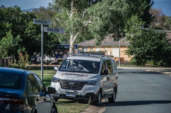 Police officers and forensic staff attend the scene of an overnight shooting and arson attack in Harrington circuit, Kambah. Numerous bullets have hit the home and three vehicles have been set alight. 