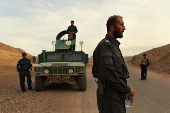 Uruzgan Police Chief, Matiullah Khan, 2nd from right, surrounded by his men on the Tarin Kowt to Kandahar highway, on the outskirts of Tarin Kowt town.