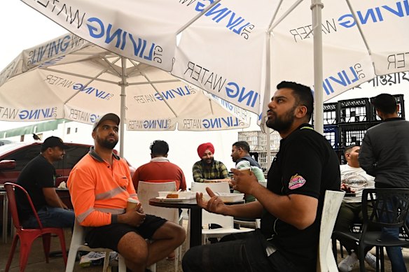 Men eat a meal at a restaurant in Harris Park.