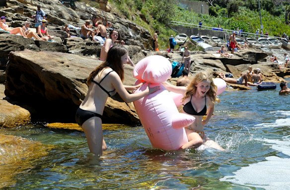 Swimmers celebrate New Years Day with their floaties at Gordons Bay in Sydney. 