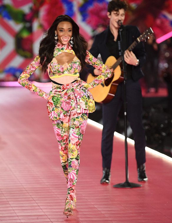 Winnie Harlow, left, walks the runway as Shawn Mendes performs during the 2018 Victoria's Secret Fashion Show at Pier 94 on Thursday, November 8, 2018, in New York. 