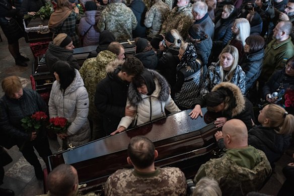 Close relatives of Sergiy Melnyk stand by his coffin during the funeral service for Oleh Yaschyshyn, Sergiy Melnyk, Rostyslav Romanchuk and Kyrylo Vyshyvany, in Lviv, Ukraine. The men died in Sunday's airstrike on the nearby International Center for Peacekeeping and Security at the Yavoriv military complex.
