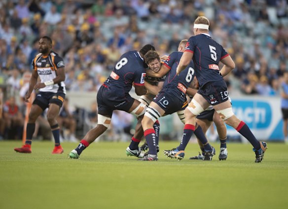 Brumbies lock Sam Carter gets wrapped up by the Rebels defence. 