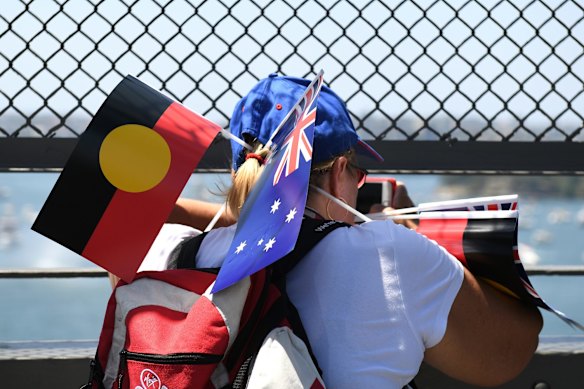 A spectator take photographs from the Sydney Harbour Bridge during Australia Day celebrations in Sydney.