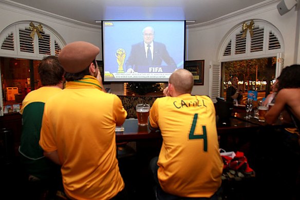 Soccer fans watch the announcement in Sydney.
