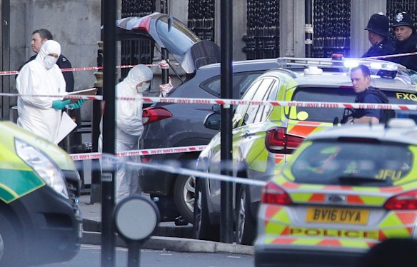 Police forensic officers at the scene close to the Houses of Parliament in London.
