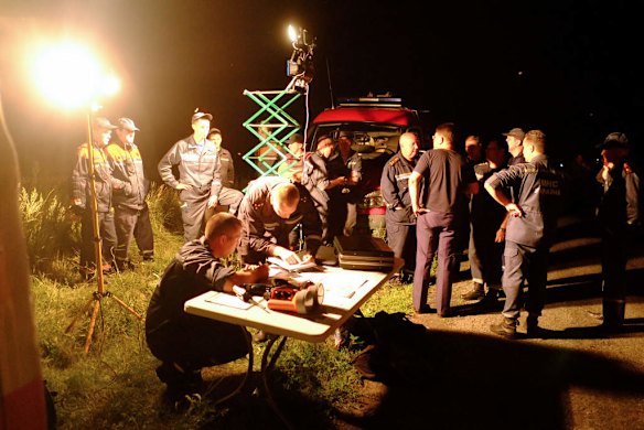 First-aid workers gather on the site of the crash of a malaysian airliner.