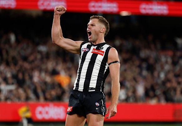 One to watch: Dan Houston celebrates a goal in front of the Magpie army.