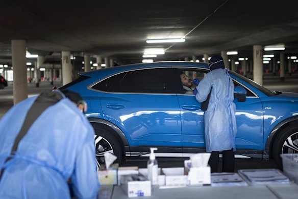 COVID-19 testing is carried out at the underground carpark at Marconi Stadium, Restwell Road, Bossley Park, as tighter lockdown restrictions are announced for Greater Sydney.