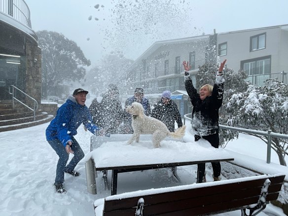 Rob Aivatoglou (far left) owns George's Ski Hire, an institution in the Mt Buller village and founded by his dad George who's name is over the door. His wife Andrea (far right) and dog Dusty with some excited staff are busy unpacking stock and getting the store ready for opening.