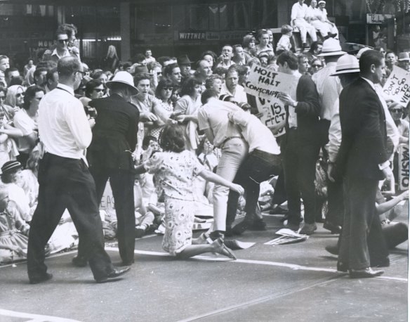 Police and civilians drag student anti-Vietnam protestors from the road when they interrupted the 1966 Moomba procession. 