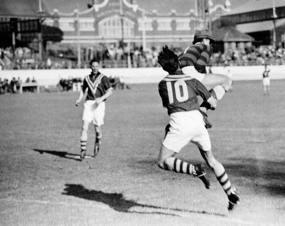 
Yugoslav goalkeeper Vladimir Beara makes a save in front of Australia's Harry Robertson during the Yugoslavia vs Australia soccer 'Test' match at the Sydney Showground on 10 September 1949.