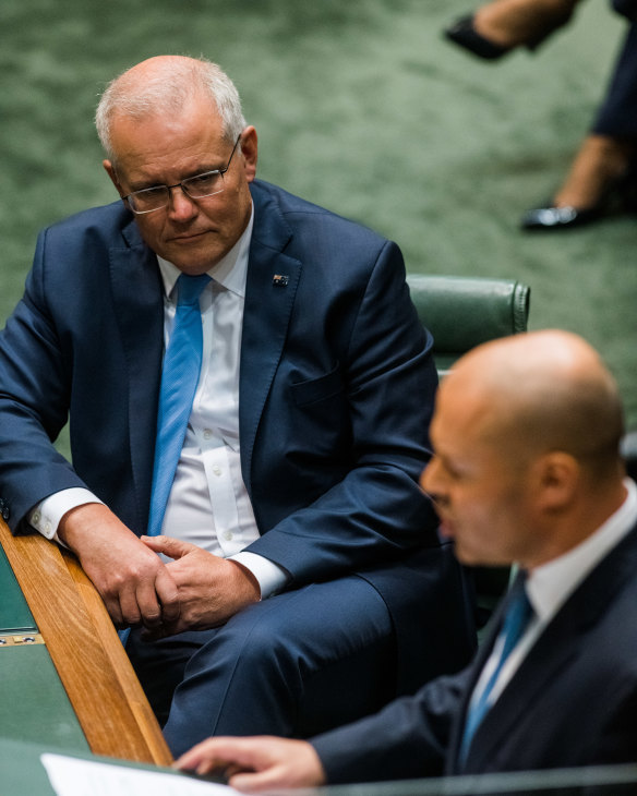 Prime Minister Scott Morrison watches as Treasurer Josh Frydenberg hands down the 2022-2023 budget at Parliament House.