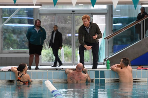 Prince Harry meets defence veteran swimmers and tours Sydney International Aquatic centre. 