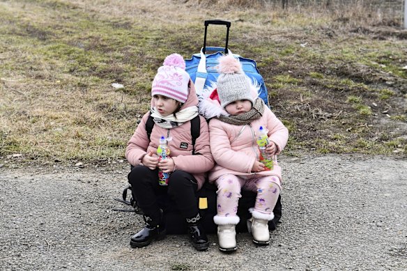 Sisters wait at a checkpoint in Beregsurany, Hungary after arriving from Ukraine. Hungary has extended legal protection to those fleeing the Russian invasion.