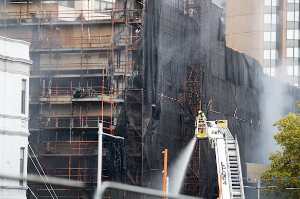 Firefighters extinguish the fire in Circular Quay.