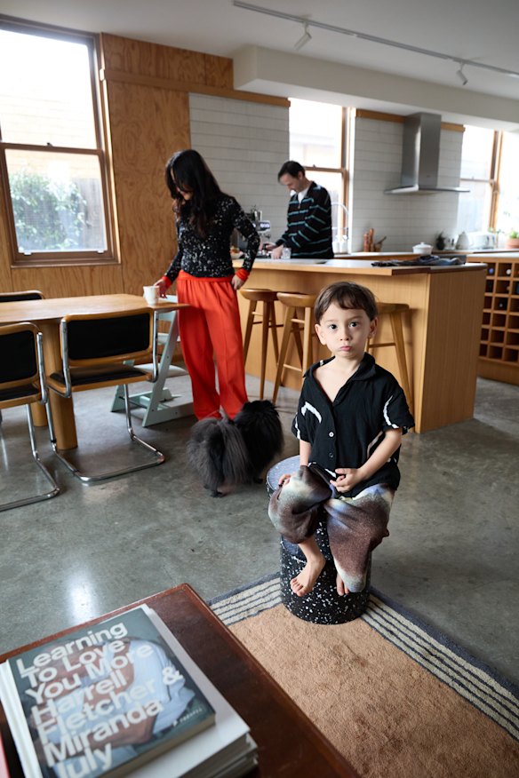 “The concrete floors were already polished when we bought, but we added rugs to
soften the space,” says Lafian. Enzo sits on a Normann Copenhagen “Bit” stool.