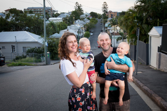 Phoebe Meredith with her husband Alex Wallace and their 18-month-old twins Hamish (stripe shirt) and Xavier (blue shirt) at their Brisbane home.