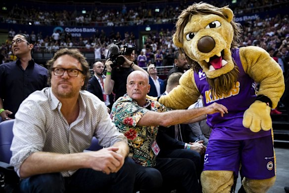 Paul Smith hangs out with the Sydney Kings mascot as Luc Longley looks on.
