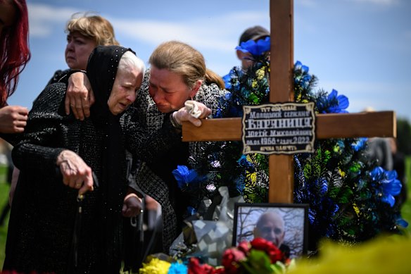 Family members mourn at the graveside of soldier Yuri Varyanytsia during the simultaneous burial of three soldiers in the Field of Mars at Lychakiv cemetery in Lviv.