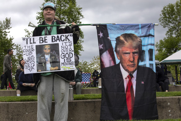 Paul Roblyer from Portland, Oregon, holds a flag of with an image of former President Donald Trump at a second amendment rally on May 1.