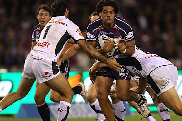 Adam Blair of the Storm is tackled.