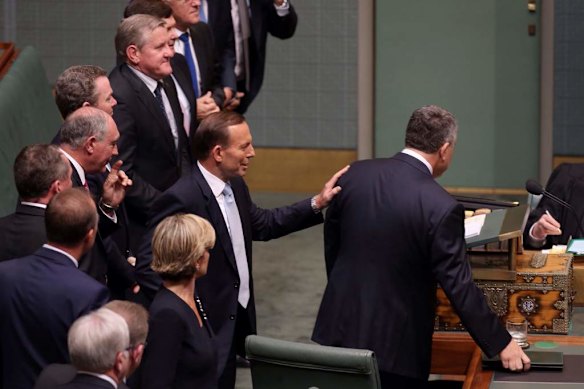 Prime Minister Tony Abbott congratulates Treasurer Joe Hockey after he delivered his first budget.