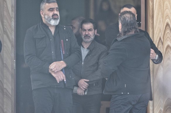 Attendees wait at the entrance to the church for Lametta Fadlallah's funeral.