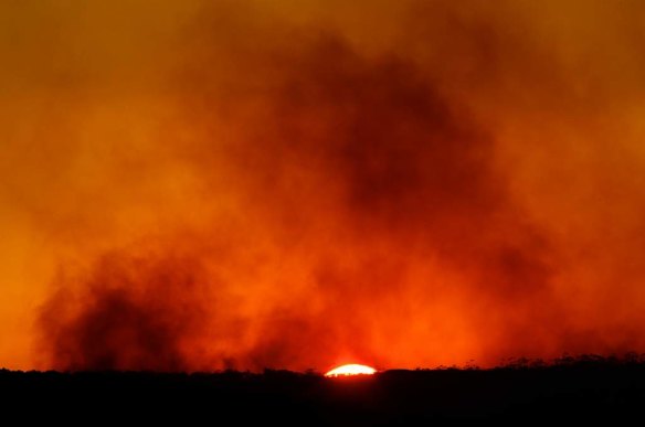 Plumes of smoke from rise from flare ups from the State Mine Fire as the sun sets along the Bells Line of Road in the Blue Mountains.