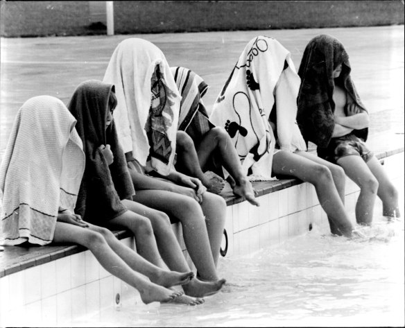 "These children at Victoria pool, Sydney, took no chances of having their eyes damaged by today's eclipse of the sun." October 23, 1976.