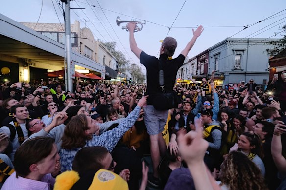 Richmond supporters celebrating their teams win over Adelaide during the AFL Grand Finals in Swan st Richmond.  Photo Luis Enrique Ascui