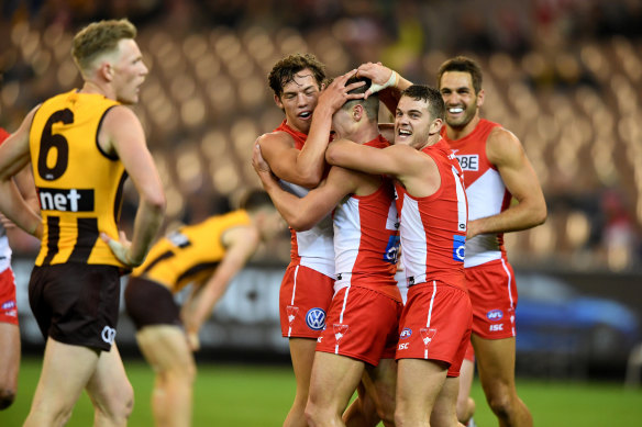 Ben Ronke (centre) is congratulated by Swans teammates after kicking his fifth goal.