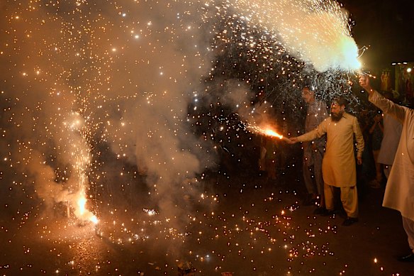 People light fireworks to celebrate Pakistan and India reaching a ceasefire deal.