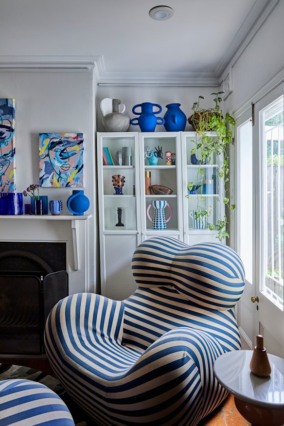 The sitting room features a Gaetano Pesce UP5/6 armchair, Harry Bayston art on the wall and Coffey’s blue vases from her Studio Saama collection atop the cabinet.