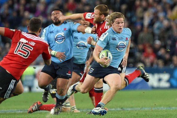 Captain's knock: Waratahs flanker Michael Hooper makes a break while a few fists fly in the background.