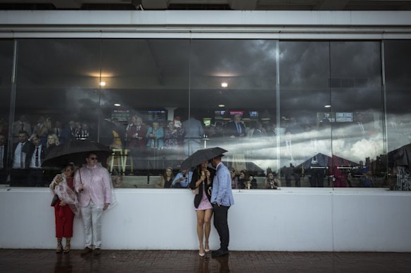 Punters seek shelter from the hail storm.
