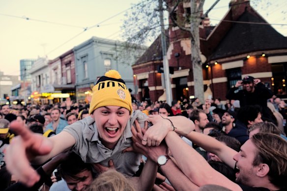 Richmond supporters celebrating their teams win over Adelaide during the AFL Grand Finals in Swan st Richmond.  Photo Luis Enrique Ascui