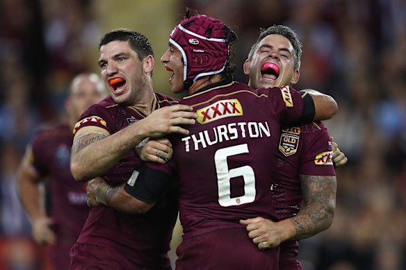 Matt Gillett, Johnathan Thurston and Corey Parker of the Maroons celebrate victory during game two