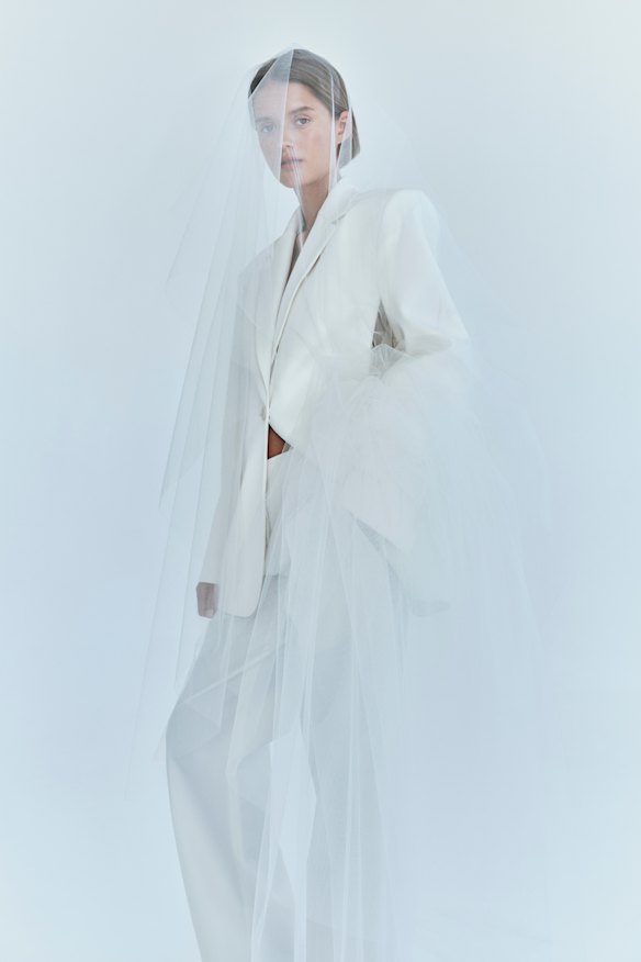A structured white suit with a chiffon bow from Australian designer Christopher Esber’s bridal collection.