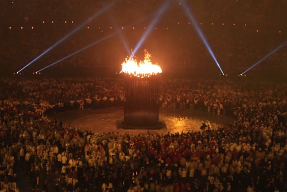 The cauldron is spectacularly lit by the Olympic flame.