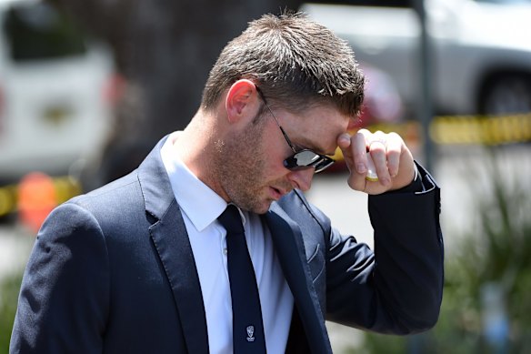 Australian Test cricket captain Michael Clarke reacts as he arrives for the funeral of Australian batsman Phillip Hughes in his home town of Macksville in northern New South Wales on December 3, 2014. Cricket bats stood silent sentry outside schools and homes, many adorned with messages for their favourite son, as the small Australian town of Macksville came to a standstill on December 3 for the funeral of Phillip Hughes.