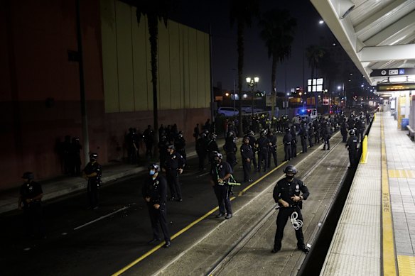 Los Angeles Police Department (LAPD) officers clear demonstrators from train tracks after declaring an unlawful assembly on election night in Los Angeles, California, U.S.